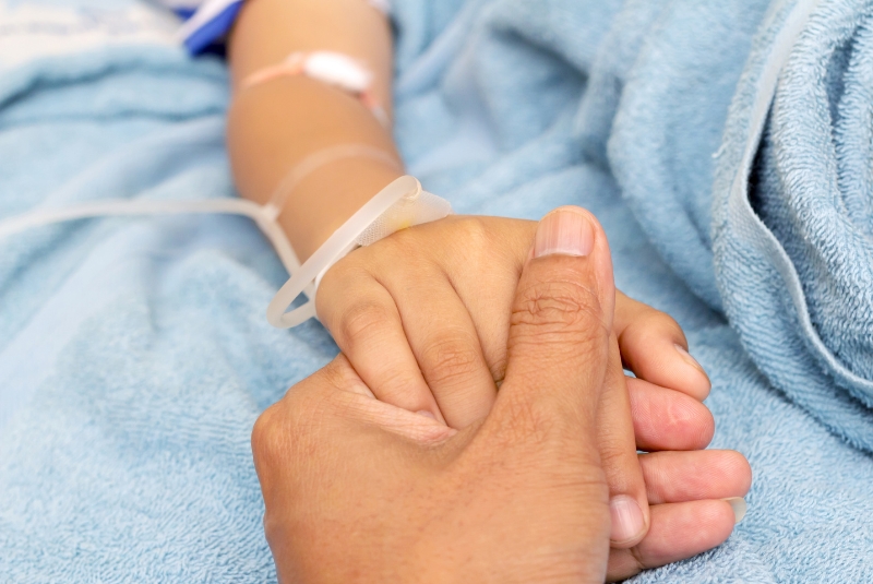 A child holding and adult's hand